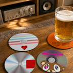 Four CD-style coasters on a wooden table with a beer mug. Three-quarter lifestyle illustration; glass and props not included.